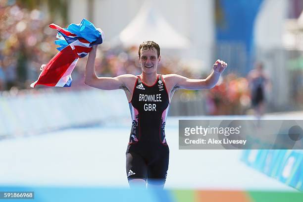 Alistair Brownlee of Great Britain crosses the finish line during the Men's Triathlon at Fort Copacabana on Day 13 of the 2016 Rio Olympic Games on...