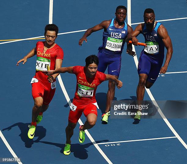 Zhenye Xie hands off to Bingtian Su of China as Christian Coleman hands off to Tyson Gay of the United States in round one of the Men's 4 x 100m...