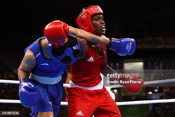 Nicola Adams of Great Britain fights against Cancan Ren of China during a Women's Fly Semifinal bout on Day 13 of the 2016 Rio Olympic Games at...