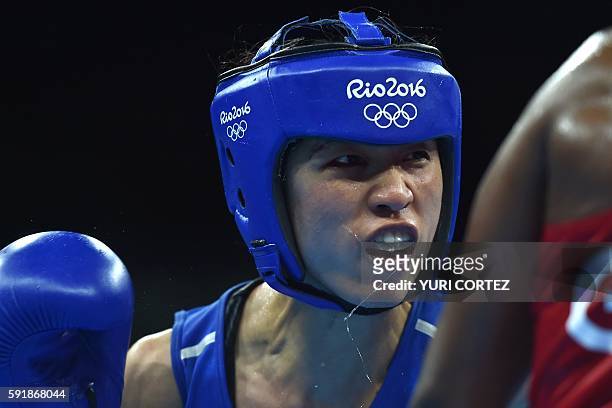 China's Ren Cancan reacts to a punch by Great Britain's Nicola Adams during the Women's Fly Semifinal 1 match at the Rio 2016 Olympic Games at the...