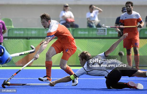 Netherlands' Seve van Ass vies with Germany's Moritz Furste during the men's Bronze medal field hockey Netherlands vs Germany match of the Rio 2016...