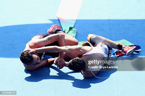 Alistair Brownlee and Jonathan Brownlee of Great Britain celebrate during the Men's Triathlon at Fort Copacabana on Day 13 of the 2016 Rio Olympic...