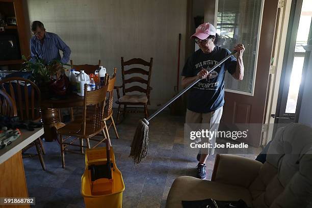 Ancil Templet and Janette Templet work on restoring their flooded home on August 18, 2016 in St Amant, Louisiana. Last week Louisiana was overwhelmed...