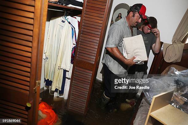 Jason Badon salvages what he can from his friends home on August 18, 2016 in St Amant, Louisiana. Last week Louisiana was overwhelmed with flood...