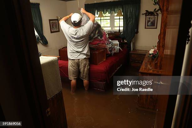 Kyle Haydel salvages what he can from his grandparents home on August 18, 2016 in St Amant, Louisiana. Last week Louisiana was overwhelmed with flood...