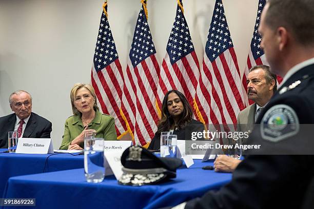 Flanked by Bill Bratton , commissioner of the New York City Police Department, and policy advisor Maya Harris look on as Democratic presidential...