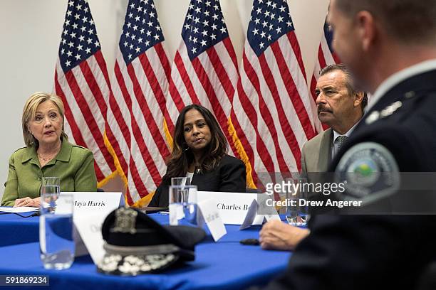 Policy advisor Maya Harris looks on as Democratic presidential candidate Hillary Clinton delivers opening remarks during a meeting with law...