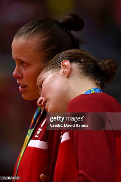 Silver medalists Christinna Pedersen and Kamilla Rytter Juhl of Denmark show their emotion during the medal ceremony for the Women's Doubles...