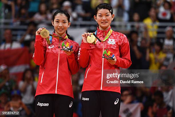 Gold medalists Misaki Matsutomo and Ayaka Takahashi of Japan pose on the podium during the medal ceremony for the Women's Doubles Badminton on Day 13...