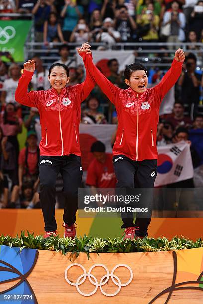 Gold medalists Misaki Matsutomo and Ayaka Takahashi of Japan pose on the podium during the medal ceremony for the Women's Doubles Badminton on Day 13...