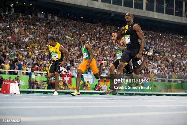 Summer Olympics: Jamaica Usain Bolt in action, crossing finish line vs Canada Andre de Grasse during Men's 100M Semifinal Rio Olympic Stadium. Rio de...