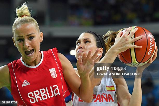 Serbia's point guard Milica Dabovic loses balance next to Spain's guard Anna Cruz during a Women's semifinal basketball match between Spain and...
