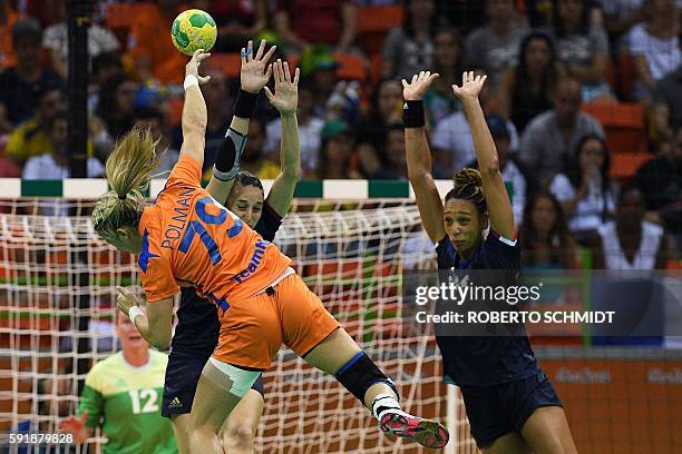 Netherlands' left back Estavana Polman shoots past France's pivot Beatrice Edwige during the women's semifinal handball match Netherlands vs France...