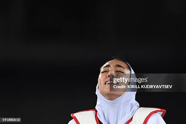 Iran's Kimia Alizadeh Zenoorin reacts after losing to Spain's Eva Calvo Gomez in their womens taekwondo quarter-final bout in the -57kg category as...