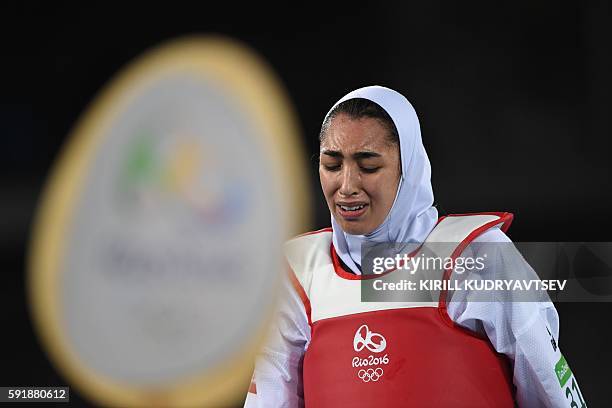 Iran's Kimia Alizadeh Zenoorin reacts after losing to Spain's Eva Calvo Gomez in their womens taekwondo quarter-final bout in the -57kg category as...