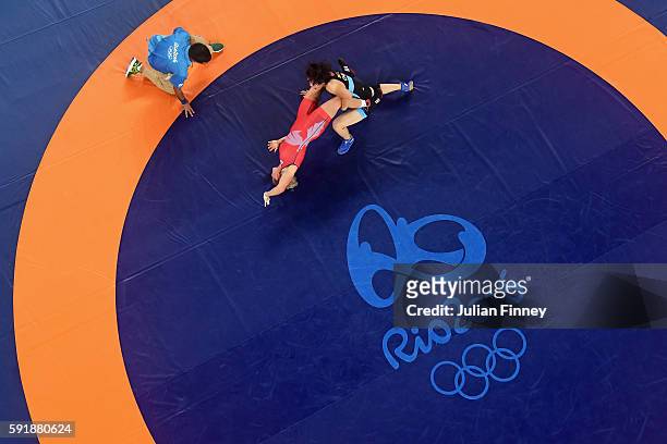 Xuechun Zhong of China competes against Yuliia Khavaldzhy Blahinya of Ukraine during the Women's Freestyle 53 kg Repechage Round 1 match on Day 13 of...