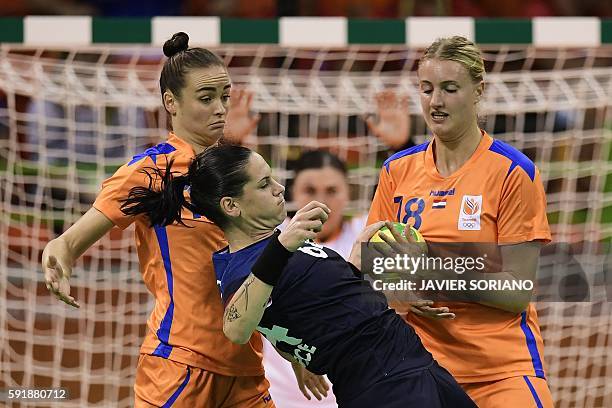 France's right back Alexandra Lacrabere vies with Netherlands' left wing Martine Smeets and Netherlands' left back Kelly Dulfer during the women's...