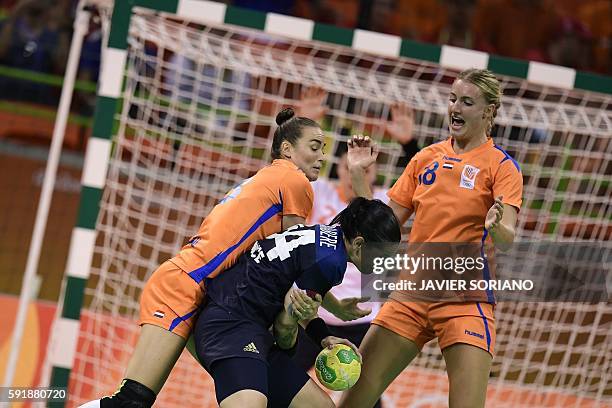 France's right back Alexandra Lacrabere vies with Netherlands' left wing Martine Smeets and Netherlands' left back Kelly Dulfer during the women's...