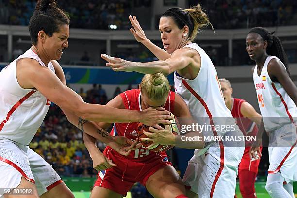 Spain's power forward Laura Nicholls and Spain's guard Anna Cruz holds off Serbia's point guard Milica Dabovic during a Women's semifinal basketball...