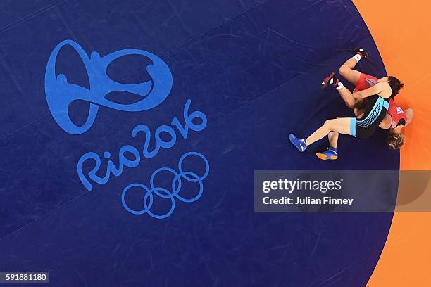 Xuechun Zhong of China competes against Yuliia Khavaldzhy Blahinya of Ukraine during the Women's Freestyle 53 kg Repechage Round 1 match on Day 13 of...