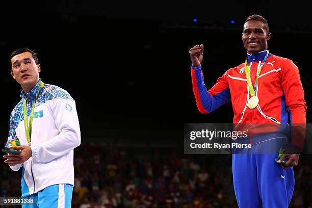 Silver medalist Adilbek Niyazymbetov of Kazakhstan and gold medalist Julio Cesar La Cruz of Cuba stand on the podium during the medal ceremony for...