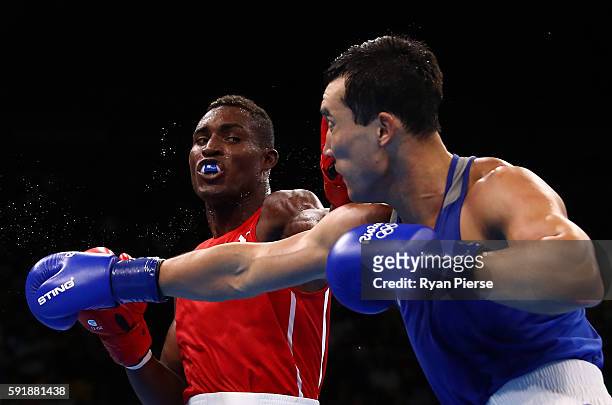 Julio Cesar La Cruz of Cuba fights against Adilbek Niyazymbetov of Kazakhstan during the Men's Light Heavy Gold Medal bout on Day 13 of the 2016 Rio...