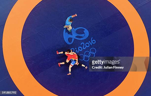Myong Suk Jong of Republic of Korea competes against Xuechun Zhong of China during the Women's Freestyle 53 kg Repechage Round 2 match on Day 13 of...