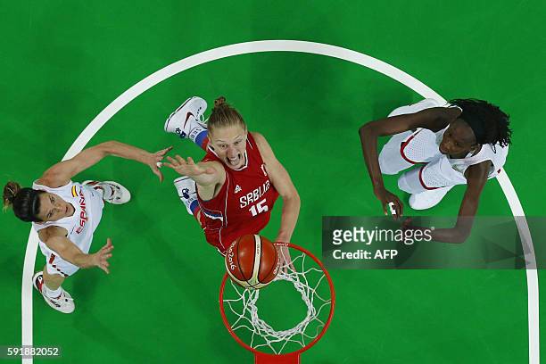 An overview shows Serbia's power forward Danielle Page jumping for a basket by Spain's guard Anna Cruz and Spain's power forward Astou Ndour during a...