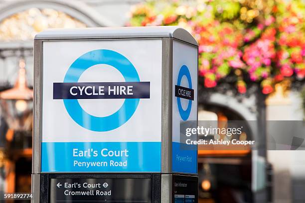 barclays cycle hire scheme, or borris bikes, part of a green initiative by transport for london. this docking station at earls court is one of many around the capital city where people, once registered can take a bike free for half an hour(charges apply a - barclays cycle hire stock pictures, royalty-free photos & images