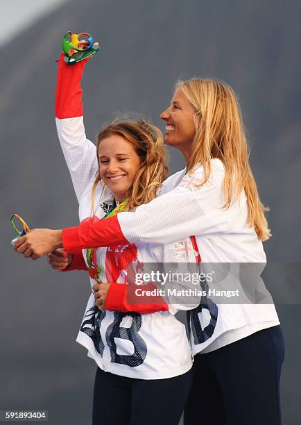 Hannah Mills of Great Britain and Saskia Clark of Great Britain celebrate winning gold in the Women's 470 class at the Marina da Gloria on Day 13 of...