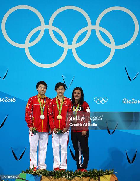 Silver medalist Yajie Si of China, gold medalist Qian Ren of China and bronze medalist Meaghan Benfeito of Canada pose on the podium during the medal...