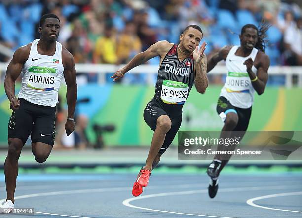 Antoine Adams of Saint Kitts and Nevis, Andre de Grasse of Canada and Brandon Jones of Belize compete during the Men's 200m Round 1 on Day 11 of the...