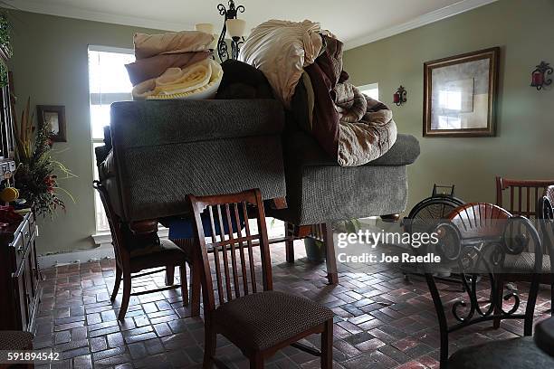 Sofa's are seen on a dining room table after the flood waters receded from the home on August 18, 2016 in St Amant, Louisiana. Last week Louisiana...