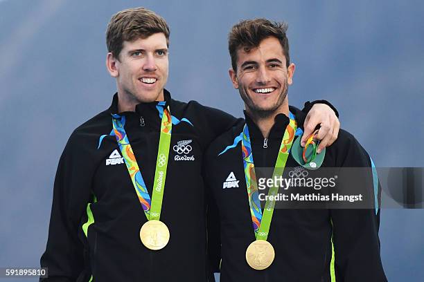 Peter Burling of New Zealand and Blair Tuke of New Zealand celebrate after winning the gold medal in the Men's 49er class at the Marina da Gloria on...