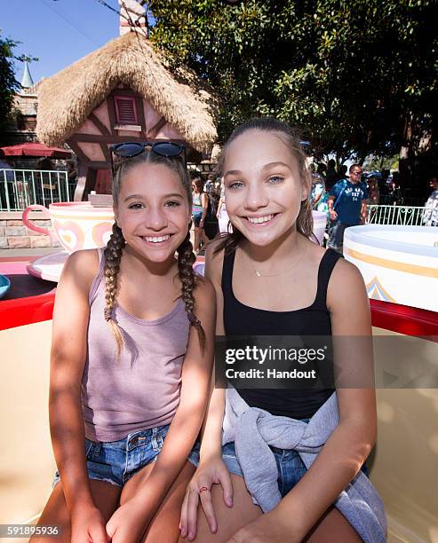 In this handout photo provided by Disneyland Resort, sisters Mackenzie Ziegler and Maddie Ziegler take a spin in a teacup at the Mad Tea Party at...