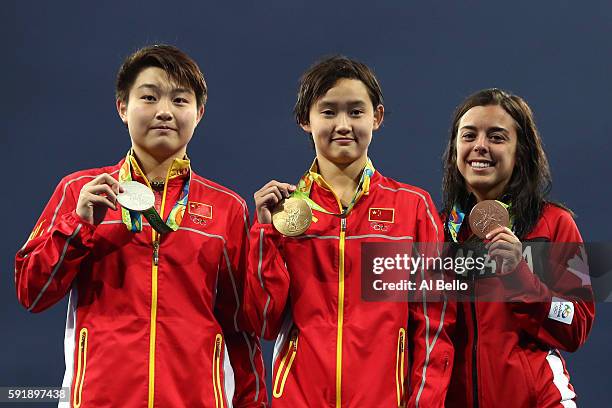 Silver medalist Yajie Si of China, gold medalist Qian Ren of China and bronze medalist Meaghan Benfeito of Canada pose on the podium during the medal...