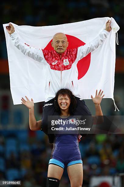 Risako Kawai of Japan celebrates with her coach Kazuhito Sakae after defeating Maryia Mamashuk of Belarus during the Women's Freestyle 63 kg Gold...