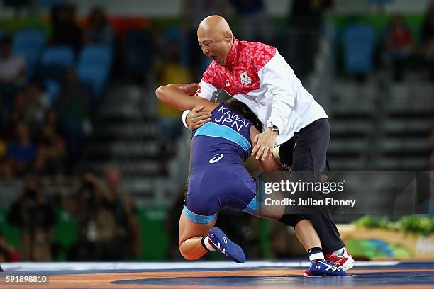 Risako Kawai of Japan celebrates with her coach Kazuhito Sakae after defeating Maryia Mamashuk of Belarus during the Women's Freestyle 63 kg Gold...