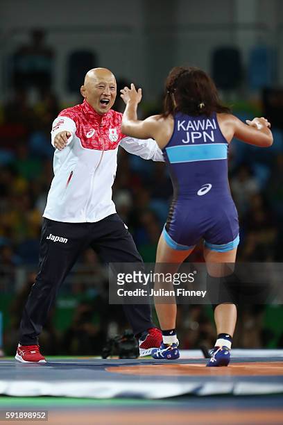 Risako Kawai of Japan celebrates with her coach Kazuhito Sakae after defeating Maryia Mamashuk of Belarus during the Women's Freestyle 63 kg Gold...