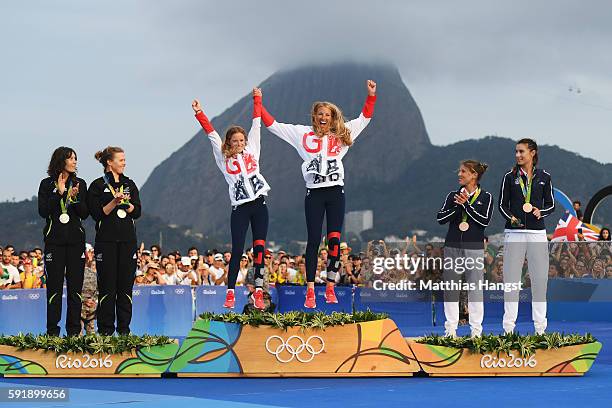 Silver medalists Jo Aleh of New Zealand and Polly Powrie of New Zealand, gold medalists Hannah Mills of Great Britain and Saskia Clark of Great...