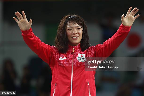 Gold medalist Risako Kawai of Japan celebrates during the medal ceremony following the Women's Freestyle 63 kg competition on Day 13 of the Rio 2016...