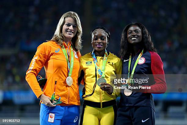 Silver medalist, Dafne Schippers of the Netherlands, gold medalist, Elaine Thompson of Jamaica, and bronze medalist, Tori Bowie of the United States,...