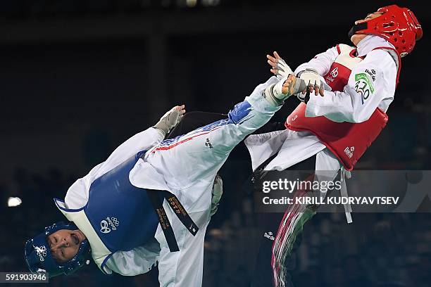 Thailand's Phannapa Harnsujin competes against Iran's Kimia Alizadeh Zenoorin during their womens taekwondo repechage bout in the -57kg category as...