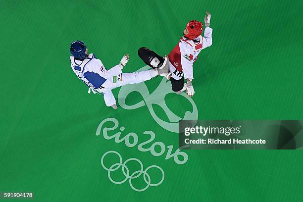 Phannapa Harnsujin of Thailand competes against Kimia Alizadeh Zenoorin of the Islamic Republic of Iran during the Women's -57kg Repechage Taekwondo...