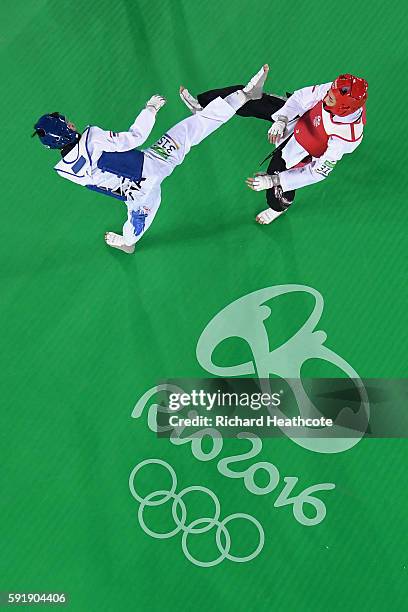 Phannapa Harnsujin of Thailand competes against Kimia Alizadeh Zenoorin of the Islamic Republic of Iran during the Women's -57kg Repechage Taekwondo...