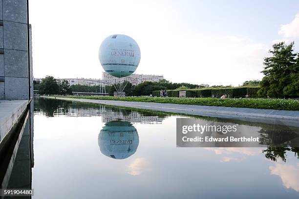 The Generali balloon relects on the water, in the Parc Andre Citroen, in the 15th quarter of Paris, on August 6, 2016 in Paris, France.