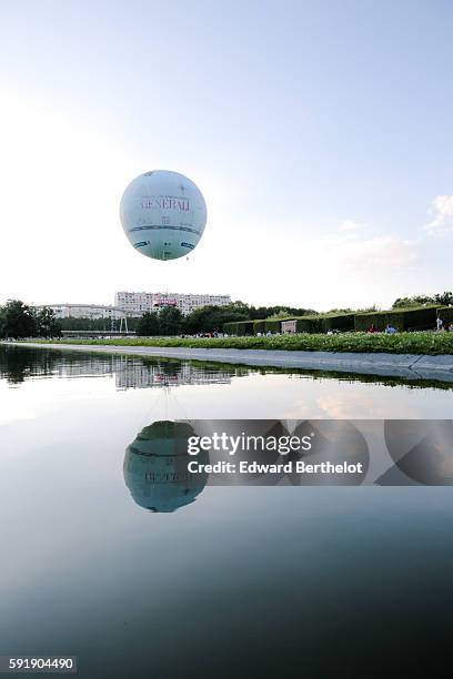 The Generali balloon relects on the water, in the Parc Andre Citroen, in the 15th quarter of Paris, on August 6, 2016 in Paris, France.