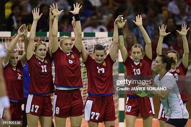 Norway's right back Nora Mork prepares to takes a free throw past Russian defenders during the women's semifinal handball match Norway vs Russia for...