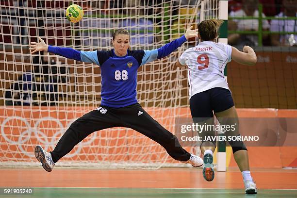 Norway's right back Nora Mork shoots at Russia's goalkeeper Viktoriia Kalinina during the women's semifinal handball match Norway vs Russia for the...