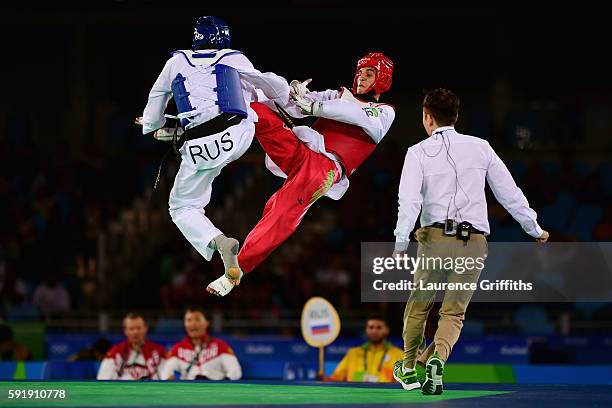 Alexey Denisenko of Russia competes against Ahmad Abughaush of Jordan during the men's -68kg Gold Medal Taekwondo contest at the Carioca Arena on Day...